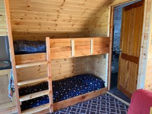 a wooden room with two bunk beds in it at Manor Farm Stay in Sutton on Sea