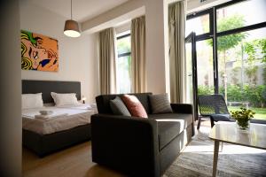 a living room with a couch and a bed at Connect Living Apartments Free Parking in Sofia