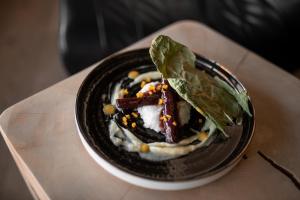 a plate of food on top of a table at Naturhotel Pfösl in Nova Ponente