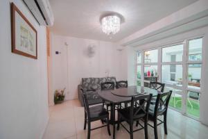 a dining room with a table and chairs at Nautilus Bay Home Inn in George Town