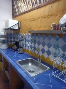 a kitchen with a sink and a blue counter top at Villa Isabel in Guaduas