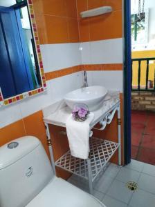 a bathroom with a white toilet and a sink at Villa Isabel in Guaduas