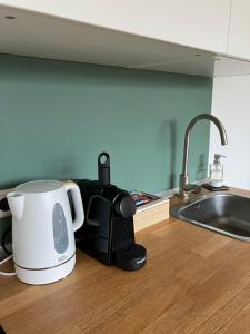 a kitchen counter with a coffee maker and a toaster at De Haarlemse Logeerkamer in Haarlem