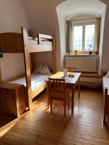 a room with two bunk beds and a table and chairs at Kloster Wernberg in Wernberg +19 photos