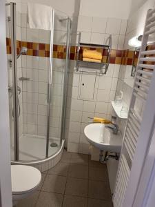 a bathroom with a shower and a sink at Kloster Wernberg in Wernberg