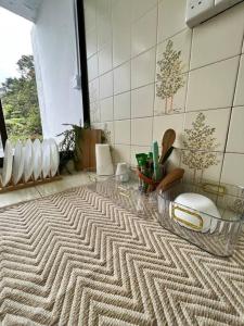 a bathroom with a zigzag rug on the floor at lily maison in Tanah Rata
