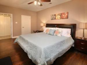 a bedroom with a bed and a ceiling fan at Large Condo in Downtown Memphis in Memphis