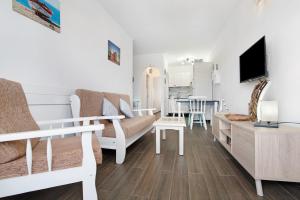 a living room with a couch and a table at Buena Fuerte Apartamentos Marino in Tarajalejo