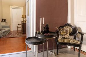 a living room with a table and two chairs at Althaia Pension in Nafplio