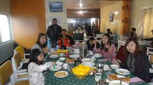 a group of girls sitting at a table eating food at Madina Hotel 2 in Gilgit