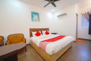 a bedroom with a bed and a table and chairs at Nautilus Bay Home Inn in George Town