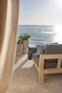 a bedroom with a laptop on a bed with a view of the ocean at The Nici Clifton Sea View Apartments in Cape Town