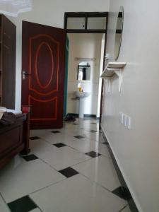 a room with a door and a checkerboard floor at Shanzu Mombasa One Bedroom & Swimming Pool in Shanzu +13 photos