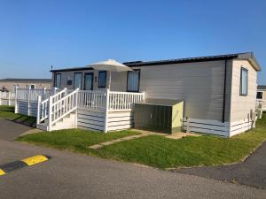 a small house with a porch and a deck at alphi3 in Bude
