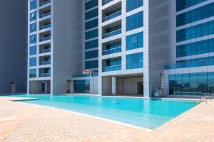 a swimming pool in front of a building at Luxery home with stunning sea view in Ajman 