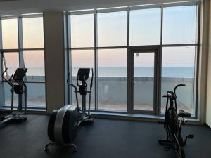 a gym with three exercise bikes in front of a window at Luxery home with stunning sea view in Ajman 
