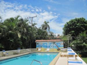 a swimming pool at a resort with a building at The Grove in Delray Beach