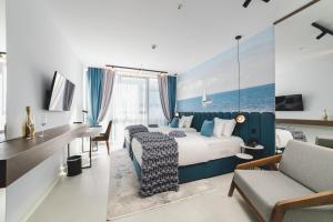 ein Hotelzimmer mit einem großen Bett und einem Schreibtisch in der Unterkunft Hotel Aurel Coast in Kotor