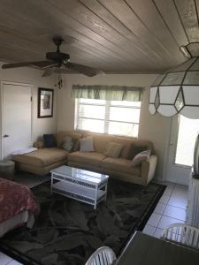 a living room with a couch and a table at The Grove in Delray Beach
