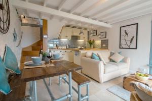 a living room with a table and a couch at Cormorant- Sea View, Couples Retreat in Brixham