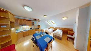 a kitchen with a blue table in the middle of a room at Apartments Kroměříž in Kroměříž