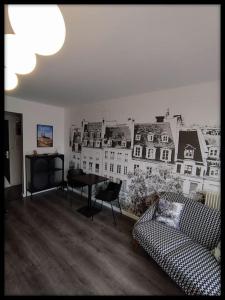 a living room with a mural of buildings on the wall at Le p'tit Beauce au Cœur de Chartres in Chartres