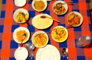 a table topped with bowls of food on a table at Koggala Lake view P&J Villa in Koggala