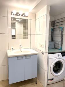 een badkamer met een wastafel en een wasmachine bij Ferienwohnung Graf in Tübingen