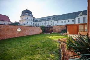 a large building with a grass yard in front of it at DEPENDANCE PATRIOT Trnava in Trnava