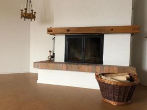 a living room with a brick fireplace with a tv at Wohnung in Burgdorf beim Schloss in Burgdorf