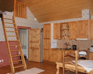 a kitchen with wooden cabinets and a ladder at Skillingaryds Gård in Skillingaryd