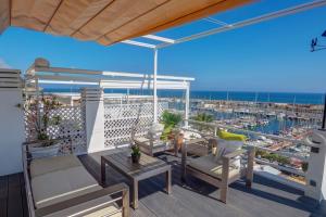 a balcony with a table and chairs and a view of a harbor at The Moonlight Sea View by Hello Homes Sitges in Barcelona