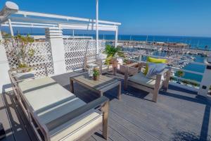 a balcony with chairs and a table and the ocean at The Moonlight Sea View by Hello Homes Sitges in Barcelona