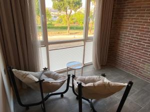 two chairs sitting in front of a window at Privet golf view house in Istanbul