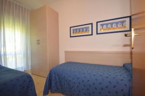 Postel nebo postele na pokoji v ubytování Villaggio Dei Gelsomini