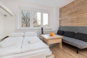 a living room with a couch and a table at Cozy studio in Downtown Gdańsk by Renters in Gdańsk