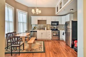 a kitchen with white cabinets and a table and chairs at Bright Apartment, Near Vicksburg Military Park! in Vicksburg