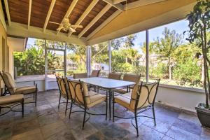 a dining room with a table and chairs and windows at Pet-Friendly Home in Vero Beach, 1 Mi to Beach! in Vero Beach