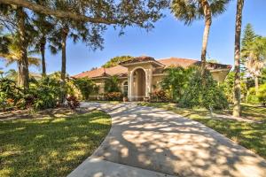a house with palm trees and a driveway at Pet-Friendly Home in Vero Beach, 1 Mi to Beach! in Vero Beach