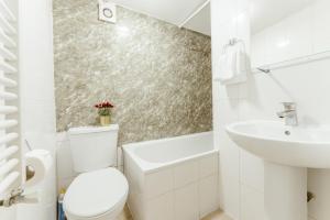 a white bathroom with a toilet and a sink at Upton Park Bedrooms 25 min to Central London in London