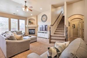 a living room with a couch and a tv at Home with Yard and ATV Access to Sand Hollow State Park! in Hurricane