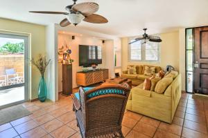 a living room with a couch and a tv at Fajardo Townhouse with Private Pool and Ocean View in Fajardo