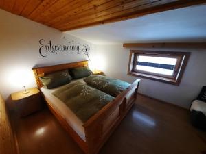 a bedroom with a wooden bed in a room with a window at Appartements Anfang in Weerberg +32 photos