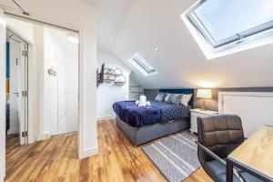 a bedroom with a bed and a couch and a window at Stunning house close to the stadium + Hot tub! in Liverpool