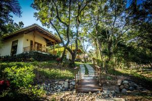 a house with a wooden walkway in front of it at BaHo Eco Beat in Ninh Hòa