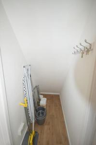 a hallway with a stairway with a room with tools at Mountain Escape - Cosy 2 bed house in Afan Valley in Port Talbot