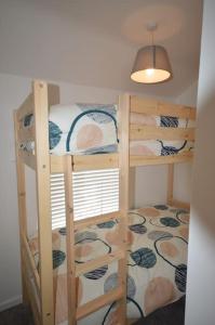 a room with two bunk beds in a room at Mountain Escape - Cosy 2 bed house in Afan Valley in Port Talbot
