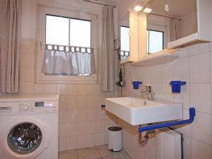 a bathroom with a sink and a washing machine at Apartment in Wenkendorf for 6 Personen in Lemkendorf +27 photos