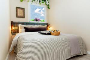 a bedroom with a large bed with a window at LikeHome Jerusalem in Jerusalem