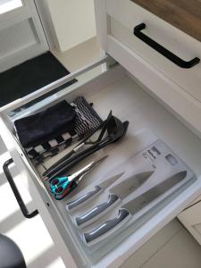a drawer in a kitchen with scissors and other kitchen utensils at Appartement S2 in Jan Thiel